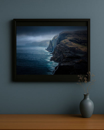 Rugged shores of Vagar Island in the Faroe Islands photography print framed on wall in living room