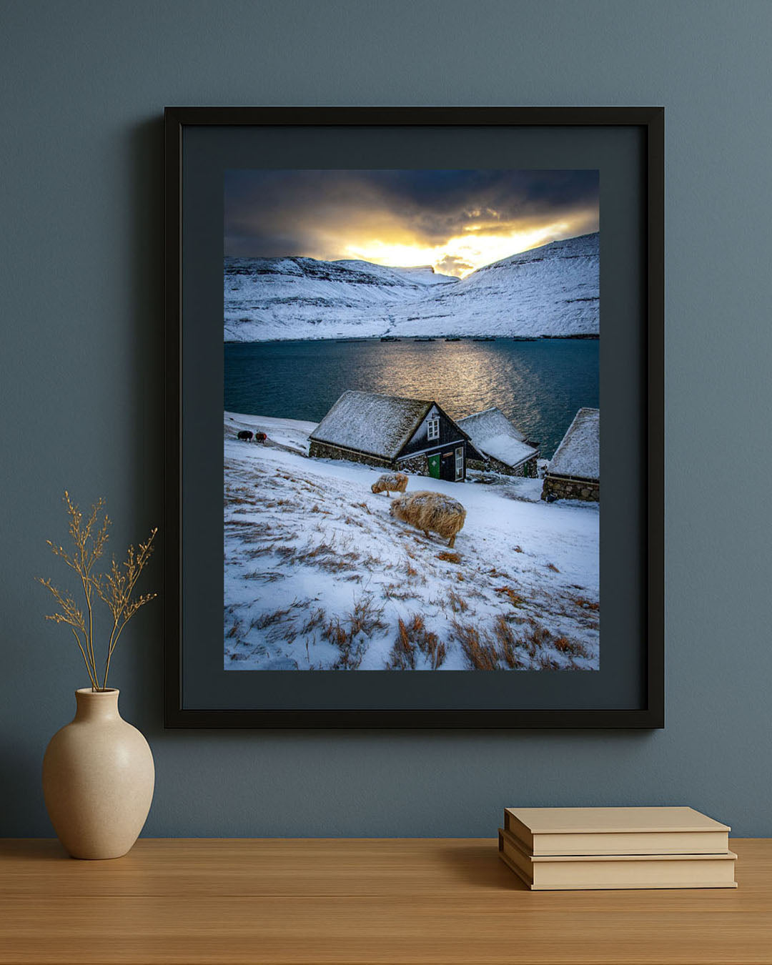 Framed photography print of winter in Bøur village, Faroe Islands, displayed on a wall