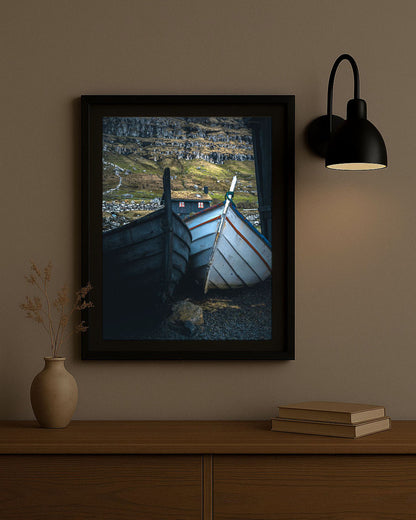 Framed photography print of Faroese wooden boats in Kirkjubøur, Faroe Islands, displayed on a wall