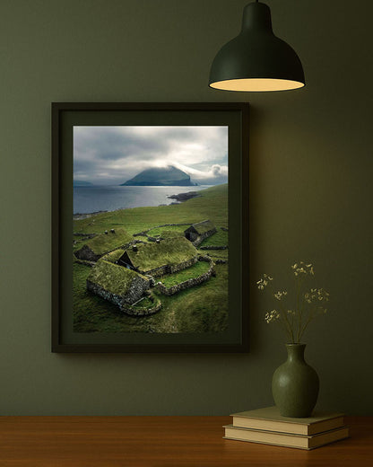 Framed photography print of Heima í Húsi on Koltur island, Faroe Islands, displayed on a wall